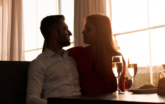 Adult couple sitting together at a restaurant table