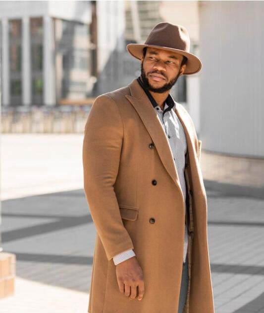 Well-dressed man walking through a city, representing the variety of careers and life stages among sugar daddy types