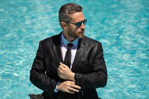 Mature, experienced man in a tailored suit, representing members in later career or retirement life stages